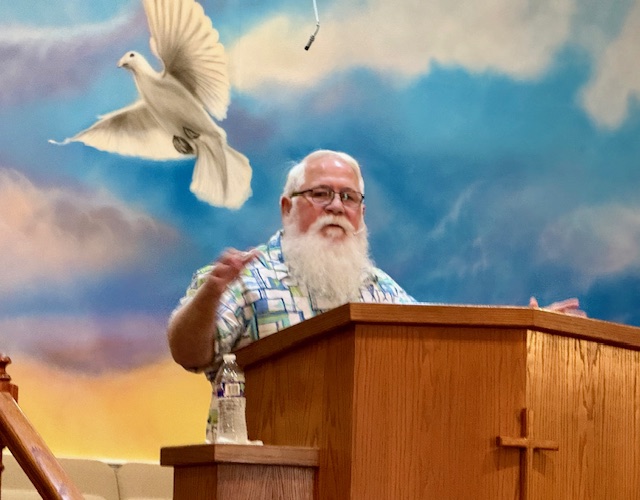 Pastor Bird Sanders preaching from the pulpit at Sugarloaf Church